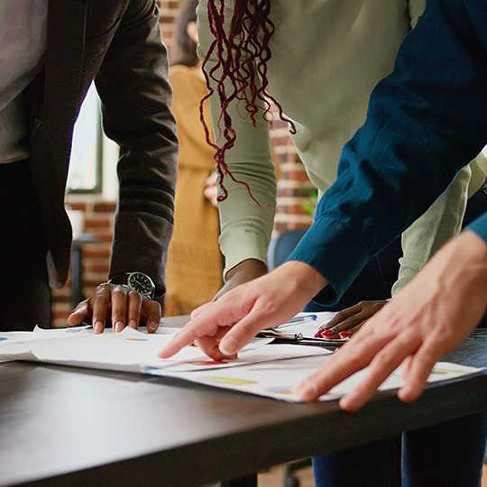 Diverse team coworker looking business charts